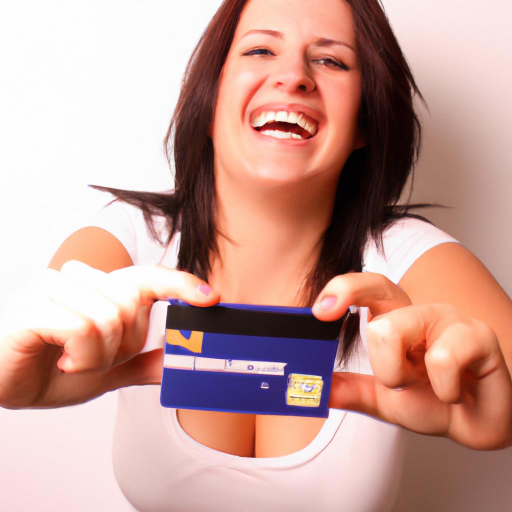 Person holding credit card, smiling